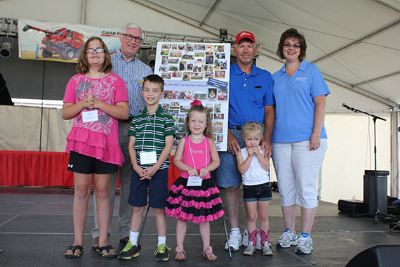 Treasurer Stenberg with four of the winners in the NEST on the Farm Fun Photo Contest at the Nebraska State Fair. From left, Elizabeth Leimser of Grand Island, Ralph Wichman of Lincoln, Isabella Shelburne of Gretna, and Rowan Lee of Grant. On the right are Mark Lee, Rowan’s grandfather, and Rachel Biar, director of the college savings program.