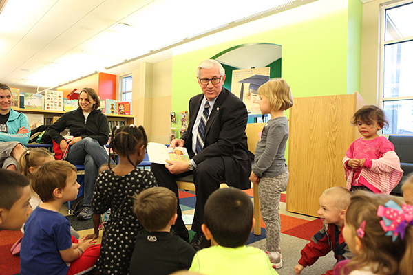 Parents and children enjoy story time at Eiseley Library in Lincoln with State Treasurer Stenberg as a guest reader.