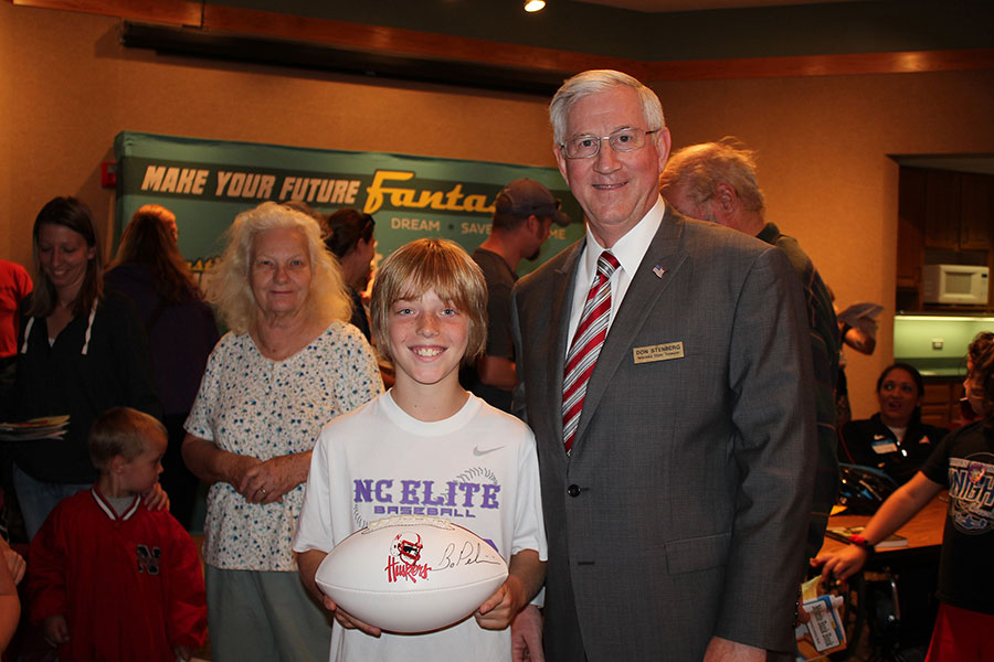 Preston Wieckhorst of Nebraska City shows off an autographed Husker football he won in a drawing at the official opening of Fantastic Future Me at the Morton-James Library in Nebraska City.