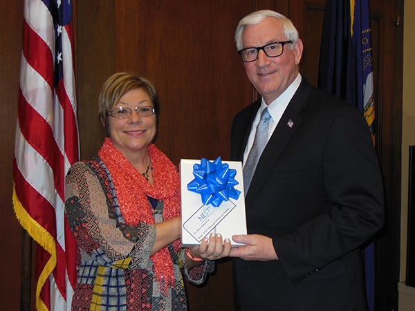 Treasurer Don Stenberg presents an iPad to Reva Richardson of Lincoln, winner of the Nebraska Educational Savings Trust sweepstakes to raise awareness of a free online tutorial about college savings available at www.treasurer.org.