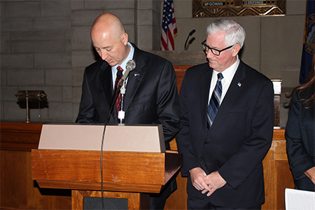 Gov. Ricketts signs the proclamation with Treasurer Stenberg looking on.