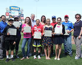 State Treasurer Don Stenberg with essay contest winners at Werner Park